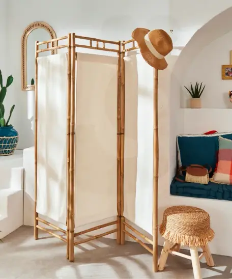 Bamboo room divider with a hat.