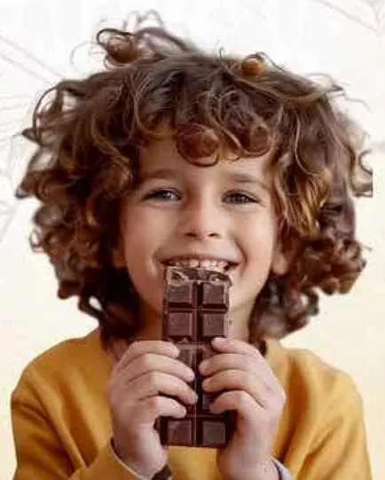 A happy child holding a chocolate bar.